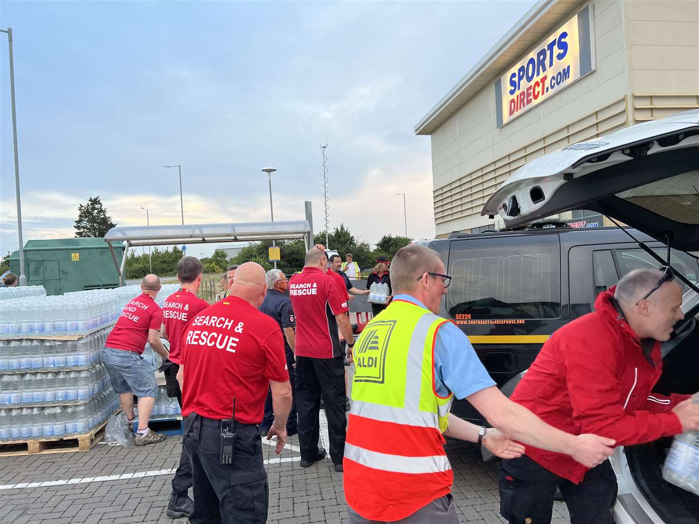 Volunteers from Kent Search and Rescue loading up a vehicle with bottled water supplies