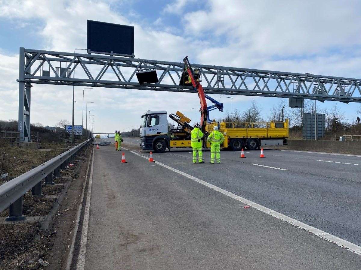 Broken signage on the gantry being dismantled as the motorway remained closed (National Highways/PA)