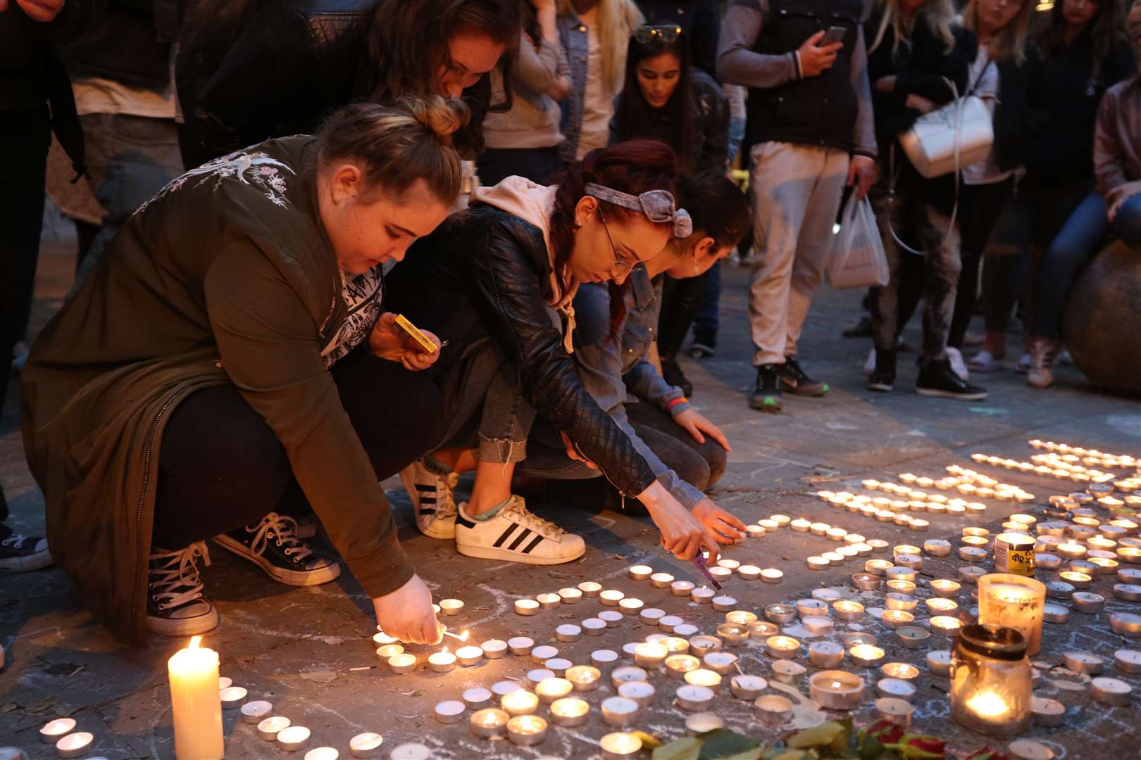 Mourners view tributes in St Ann’s Square, Manchester (Jonathan Brady/PA)