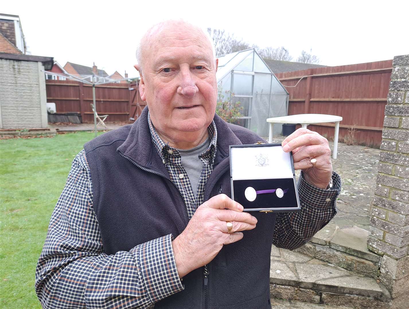 Peter Pearce with the Elizabeth Emblem presented to him for his father Leslie Pearce who died fighting the Barming hospital fire