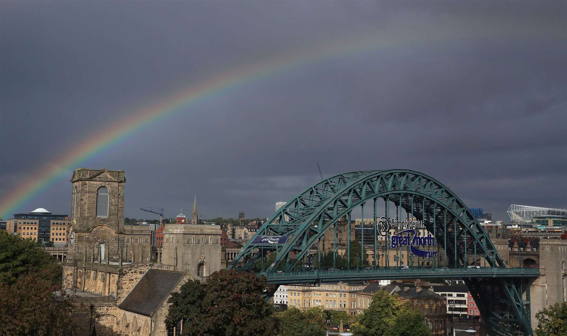 A rainbow visible over Tyne Bridge, Newcastle (Owen Humphreys/PA)