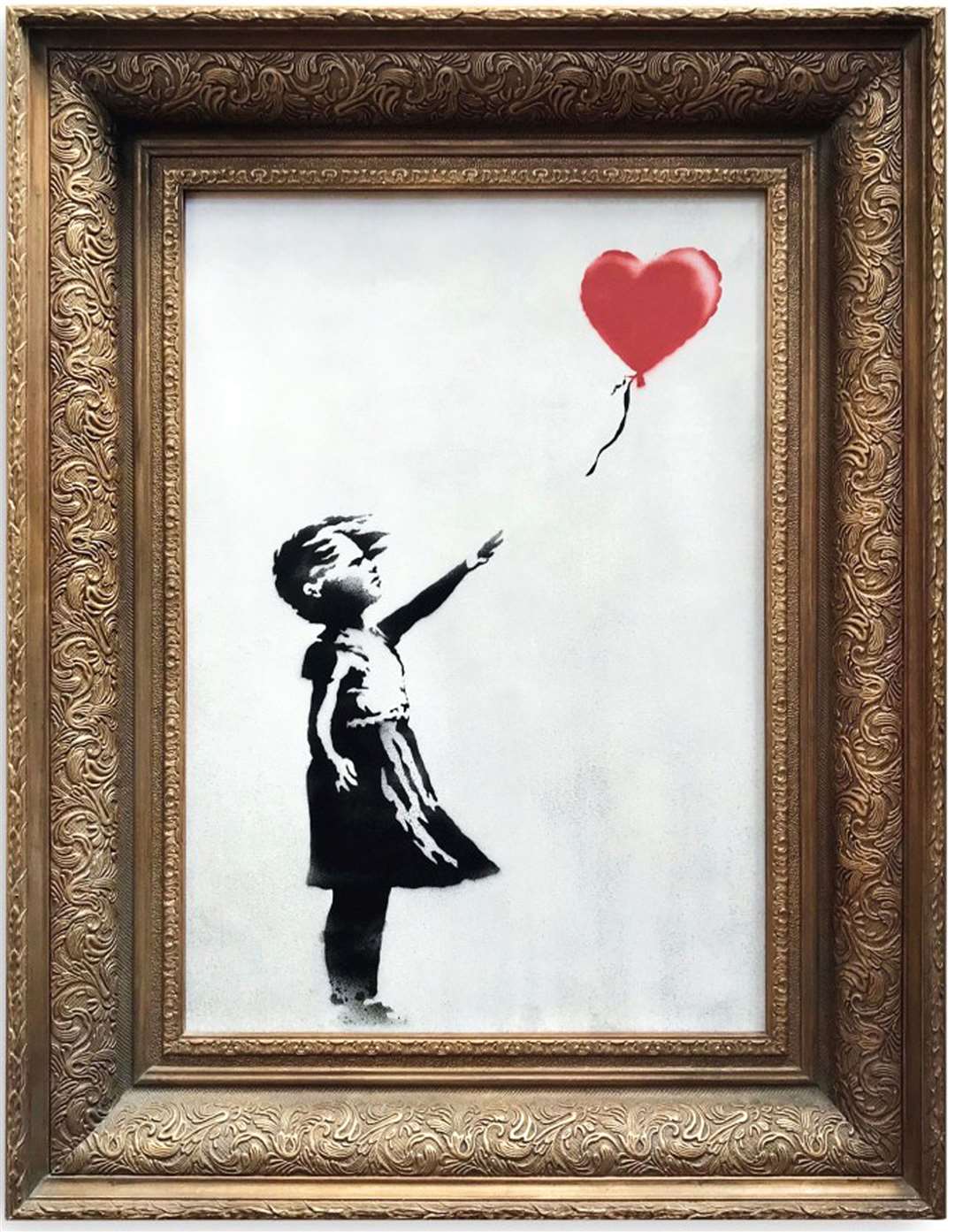 Banksy’s artwork, Girl With Balloon before it shredded itself after being sold for more than £1 million at auction (Sotheby’s/PA)