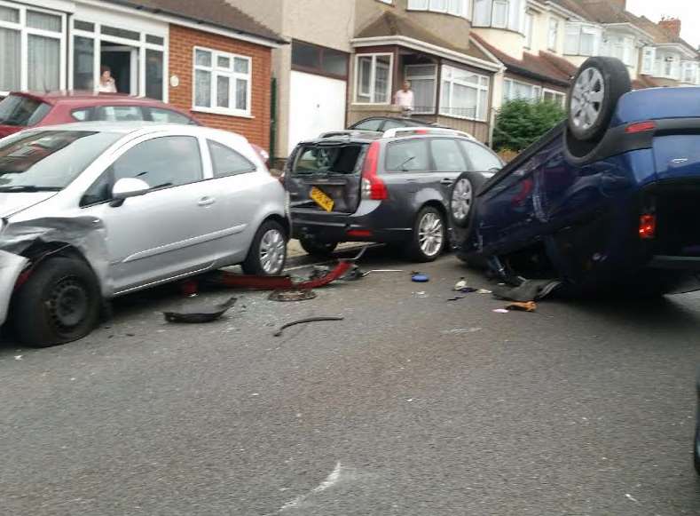 The car ended up wedged between two parked cars