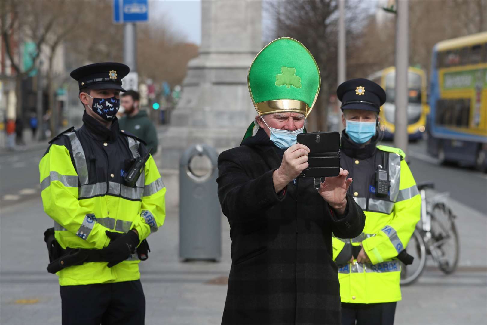 A man takes a selfie with members of An Garda Siochana (Brian Lawless/PA)