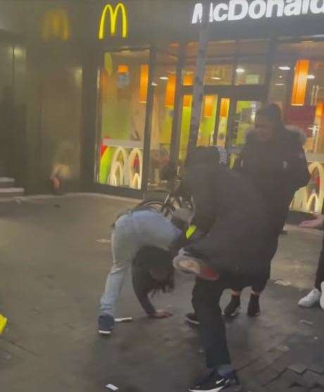 A security guard and teenager fight outside McDonald's in Week Street, Maidstone. Picture: Niomi Elvina