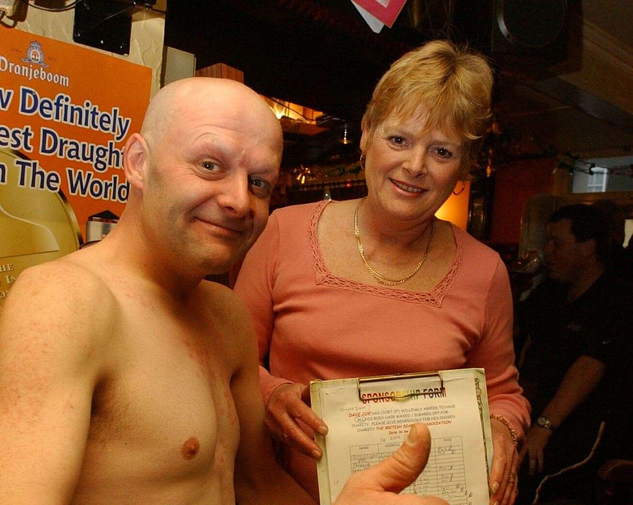 Dave Coe had all of his body hair - from the top of of his head and including eyebrows and between his toes - removed for charity at the pub. He is pictured with landlady Pam Canale. Picture: Mike Waterman