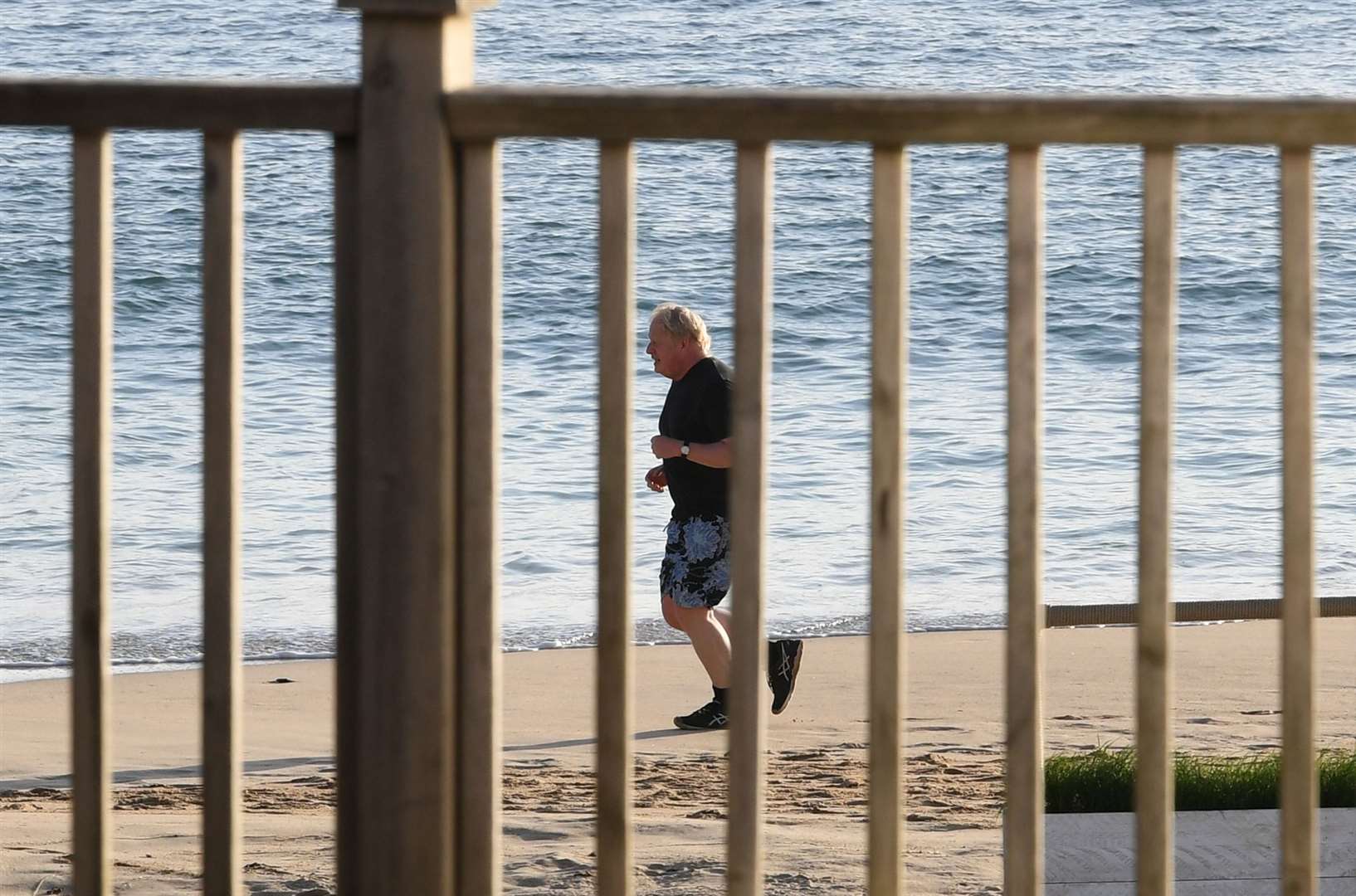 Prime Minister Boris Johnson takes an early morning run along the beach in Carbis Bay (Stefan Rousseau/PA)