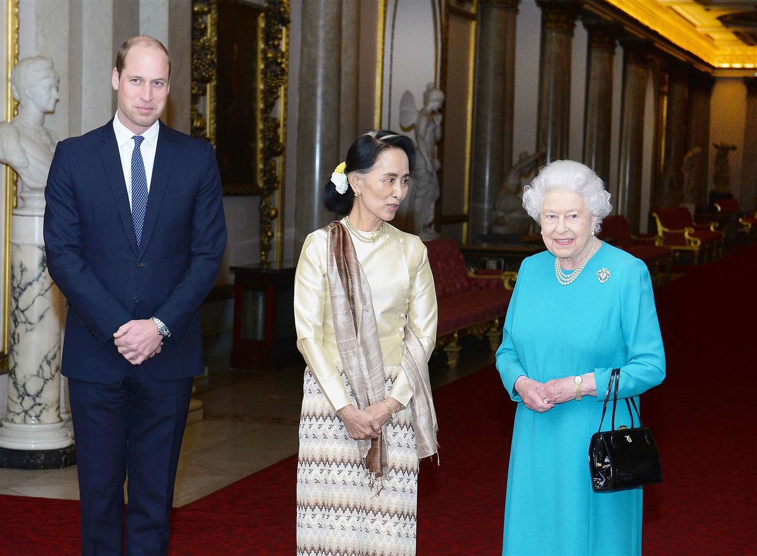 The Queen and the Duke of Cambridge greeting Ms Suu Kyi ahead of a private lunch at Buckingham Palace in London (John Stillwell/PA)