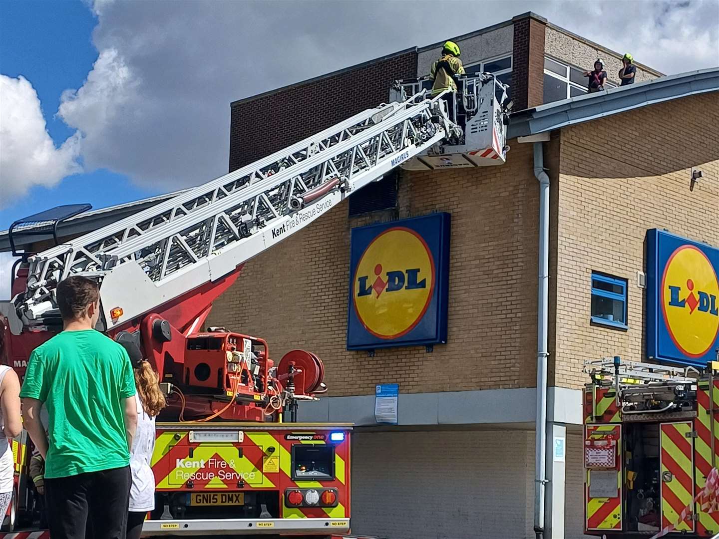 Crews were also seen taking a piece off the roof off to try and get to the cat. Picture: Rachel Knight