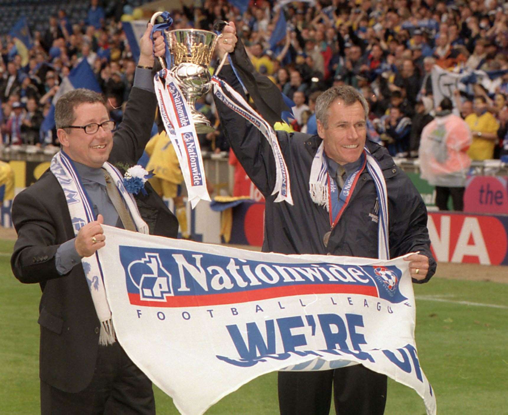 Chairman Paul Scally and manager Peter Taylor celebrate promotion on the pitch at Wembley