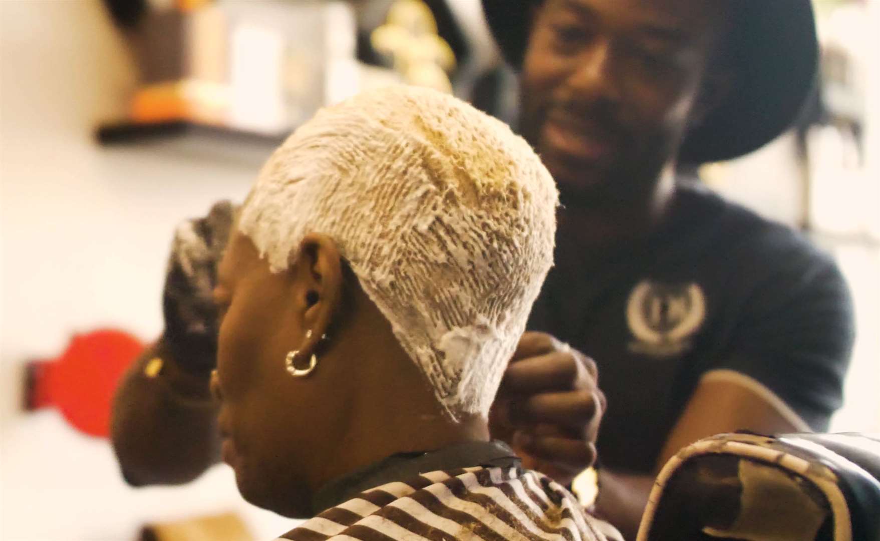A customer gets their hair bleached at Dolce B's