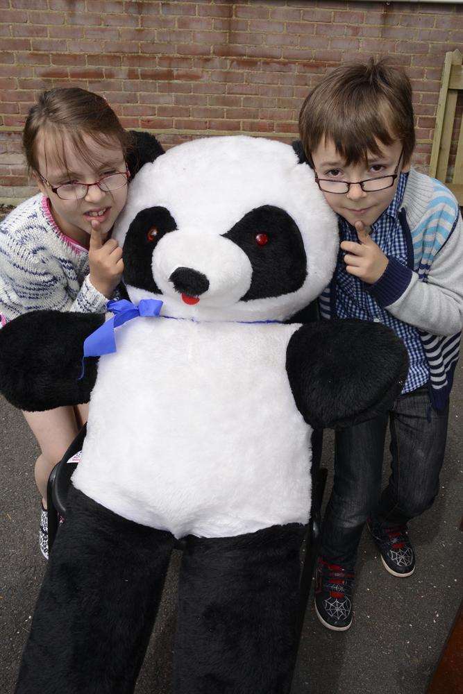 Abigail and Orlando Hancock try to guess the name of the Panda at the RSPCA Ashford cattery open day