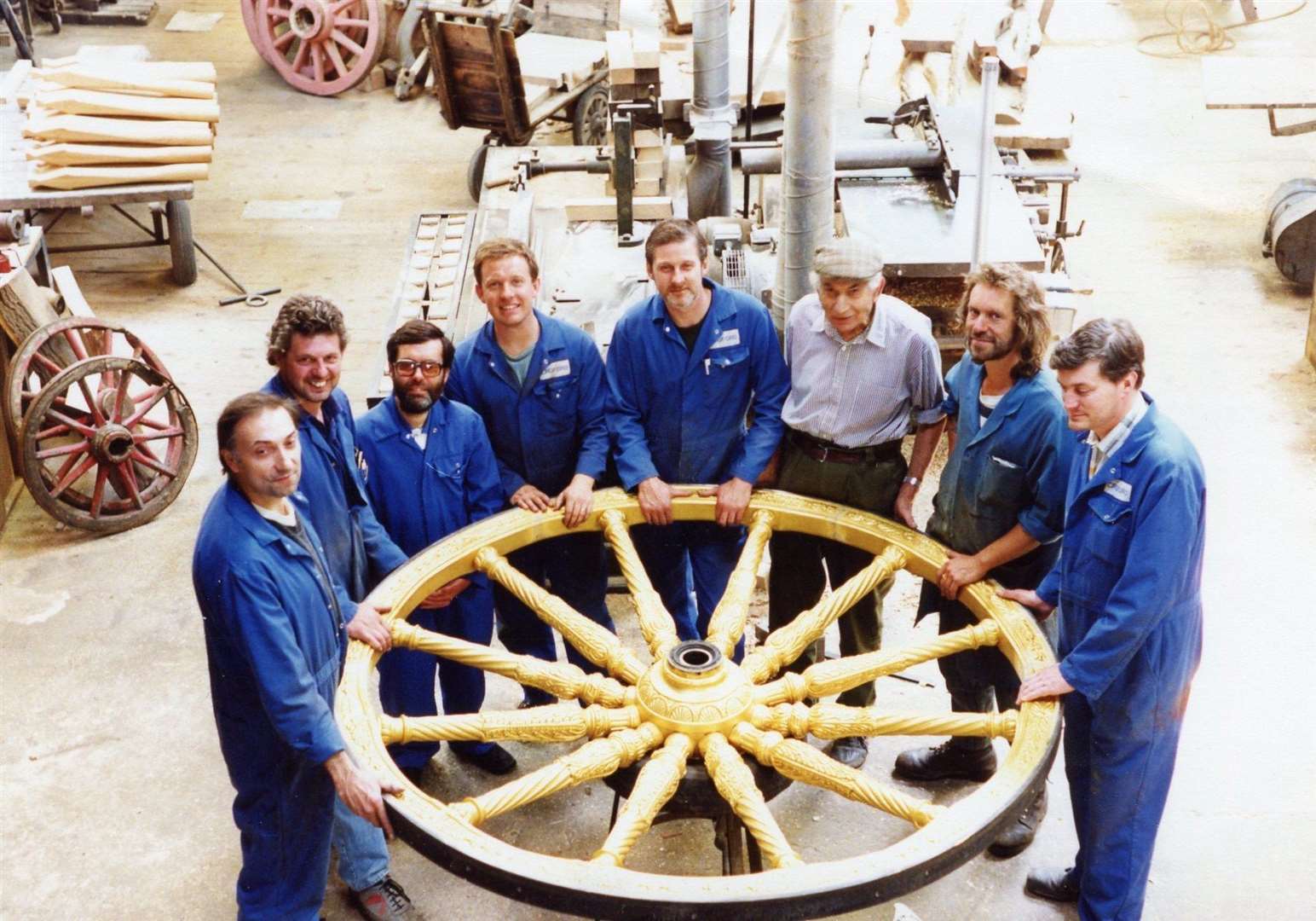 Croford’s staff holding the new wheels for the Gold State Coach used by royalty at coronations and jubilees