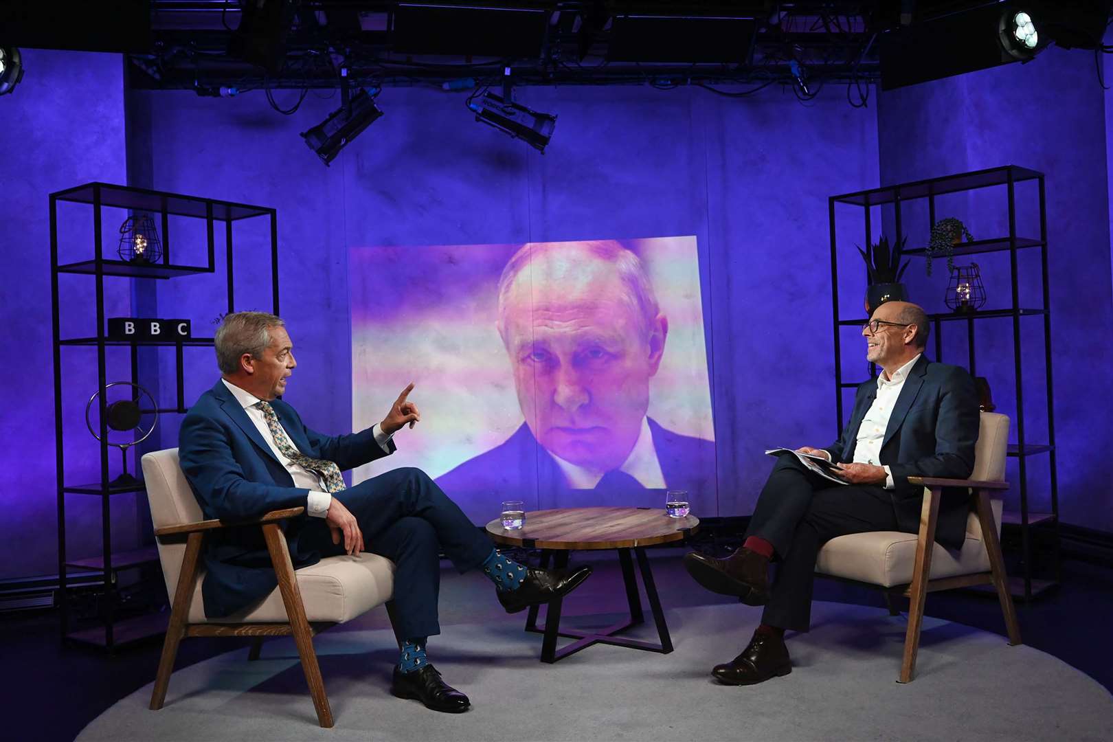 Nigel Farage, left, faced questions about his views on Russian president Vladimir Putin, projection, during the interview (Jeff Overs/BBC/PA)