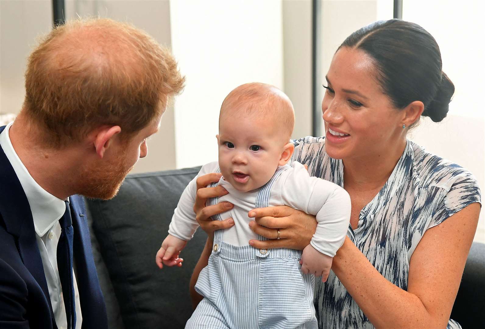 A young Archie with his parents (Toby Melville/PA)