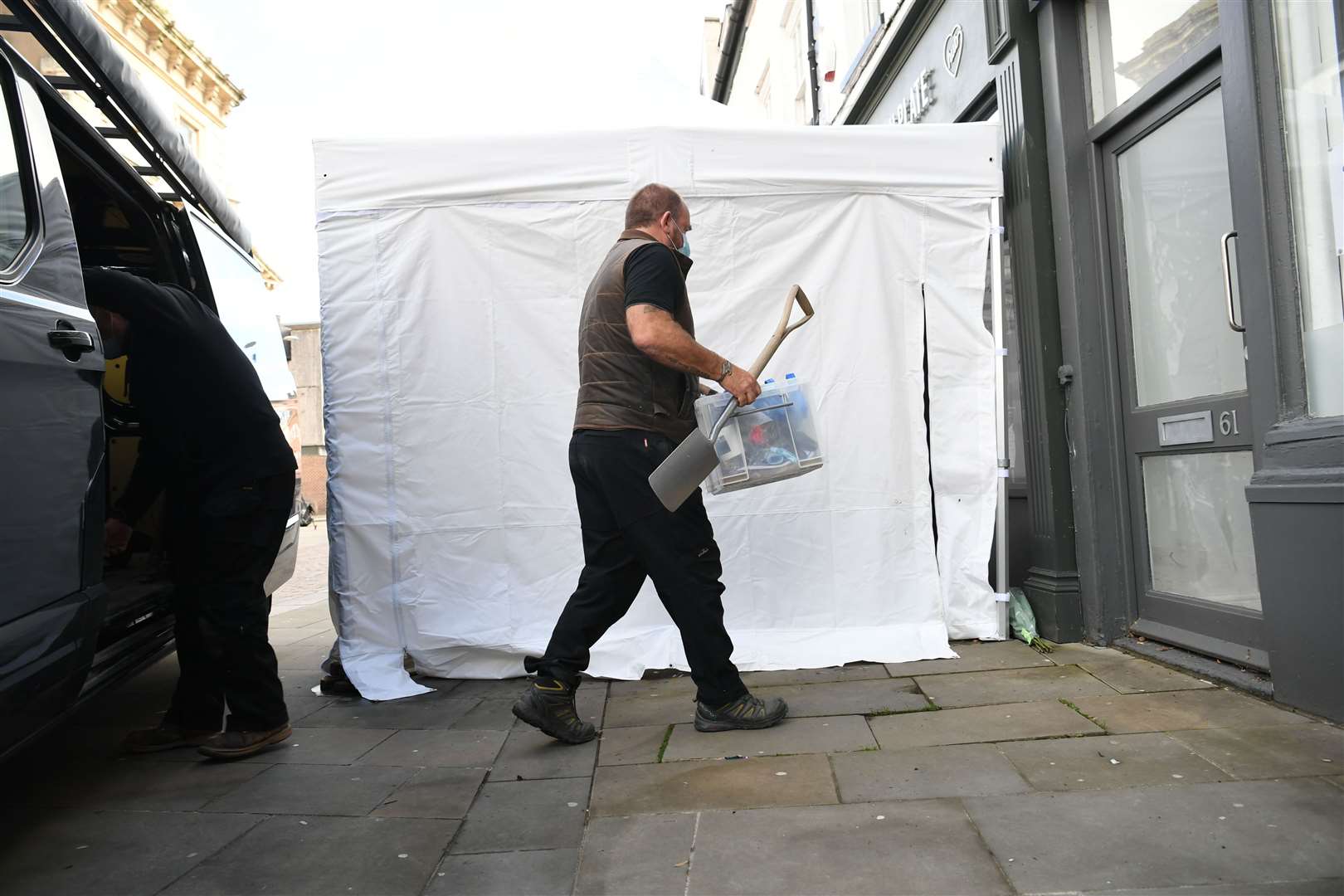 Contractors unload equipment into the Clean Plate cafe in Southgate Street, Gloucester as excavation work for missing Mary Bastholm got under way (Ben Birchall/PA)