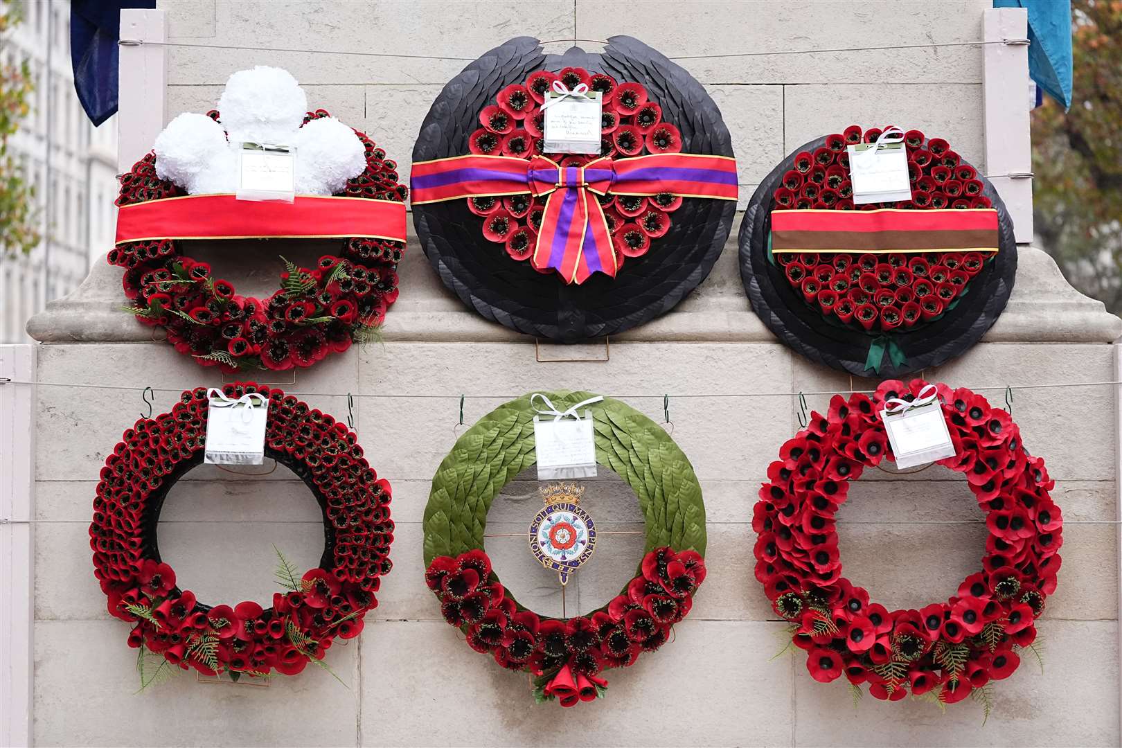 Wreaths after the Remembrance Sunday service at the Cenotaph – with the Queen’s on the far top right (Aaron Chown/PA)