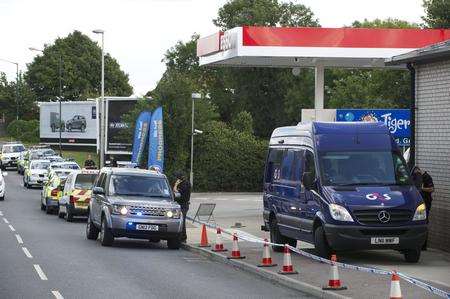 Police at the scene of the raid on Esso in Strood