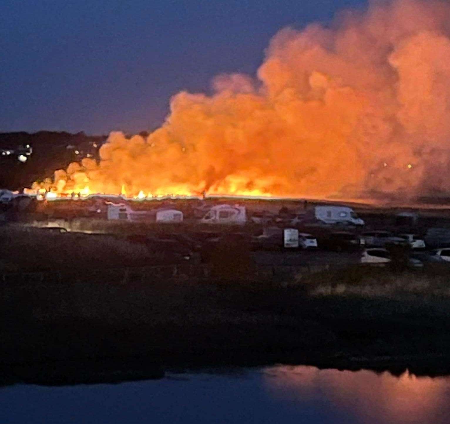 Fire and smoke billow from a huge grass fire at Barton's Point Coastal Park, Sheerness, Sheppey, on Saturday night. It is believed it was started by sparks from a model aeroplane fireworks display. Picture: Andy Gray (Facebook)