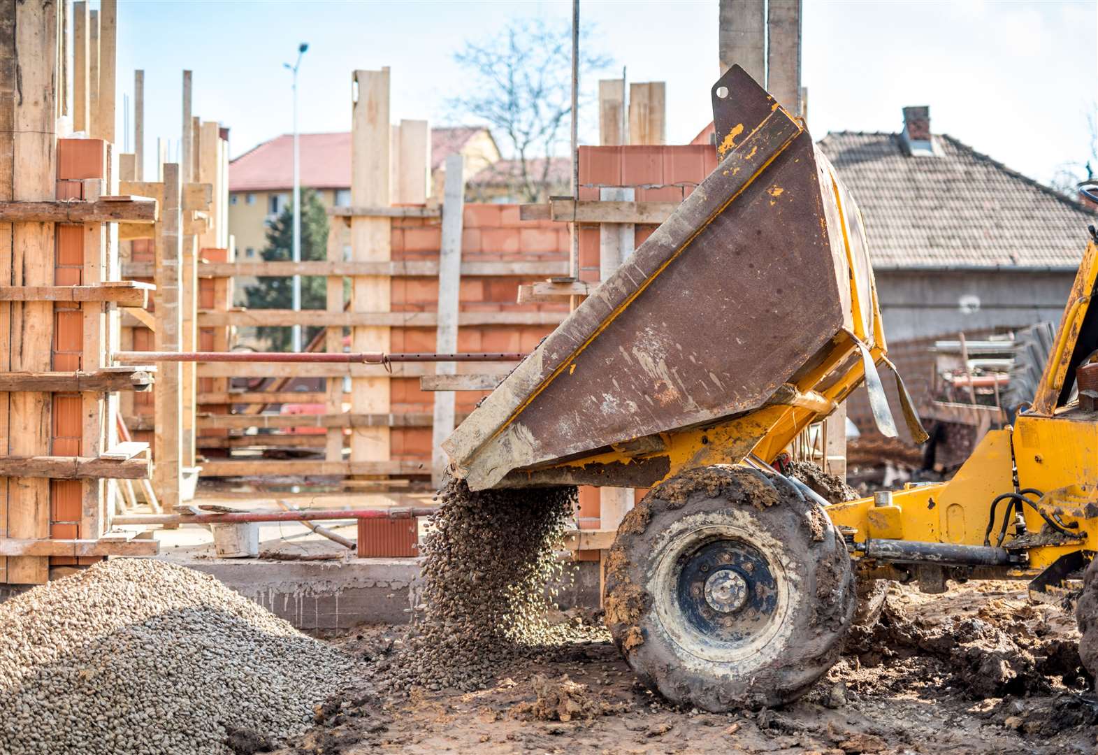 industrial truck loader excavating gravel and construction aggregates. Construction site with dumper truck and materials. (47455120)