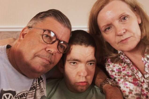 Joe Cook, 28, with his parents Martin and Tracey