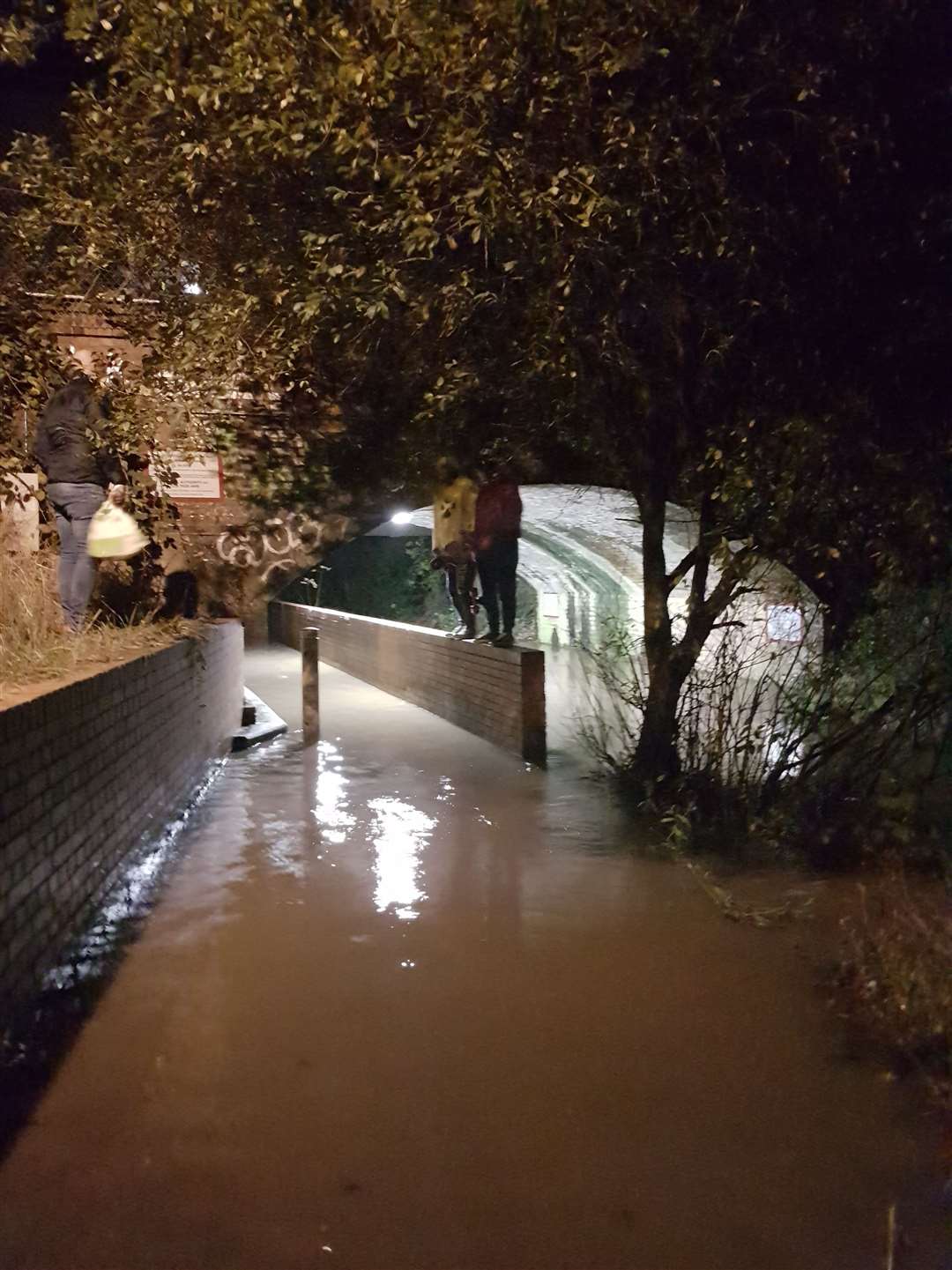 People have to cross via the wall, before traversing the water by stepping on a bollard. (21884501)