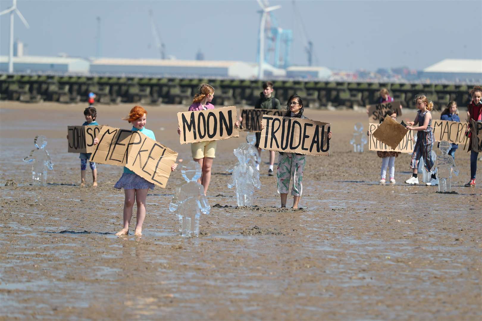 Children hold cardboard signs showing names of various world leaders (Peter Byrne/PA)