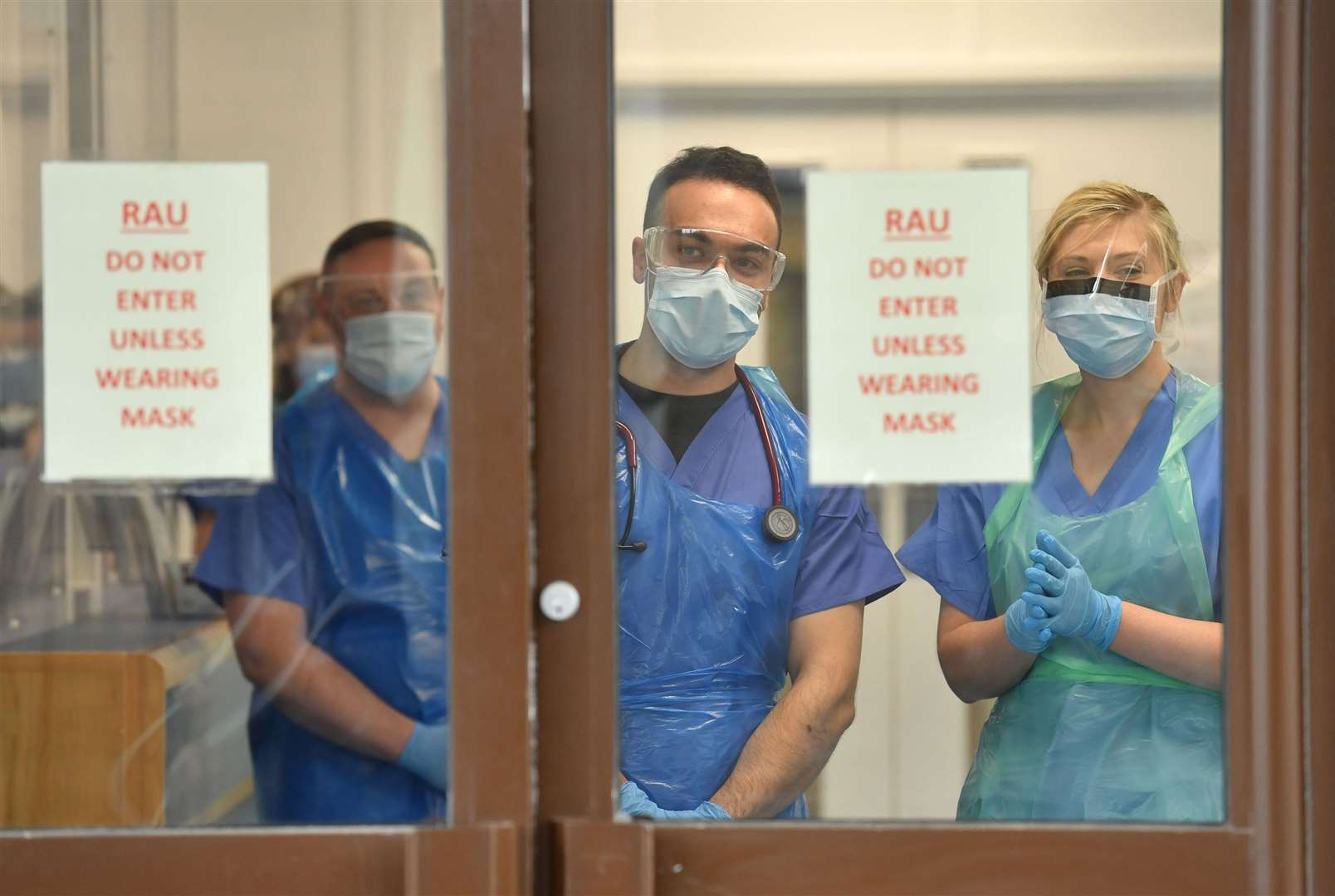 Medical staff wearing personal protective equipment await patients admitted to the ICU (Jacob King/PA)