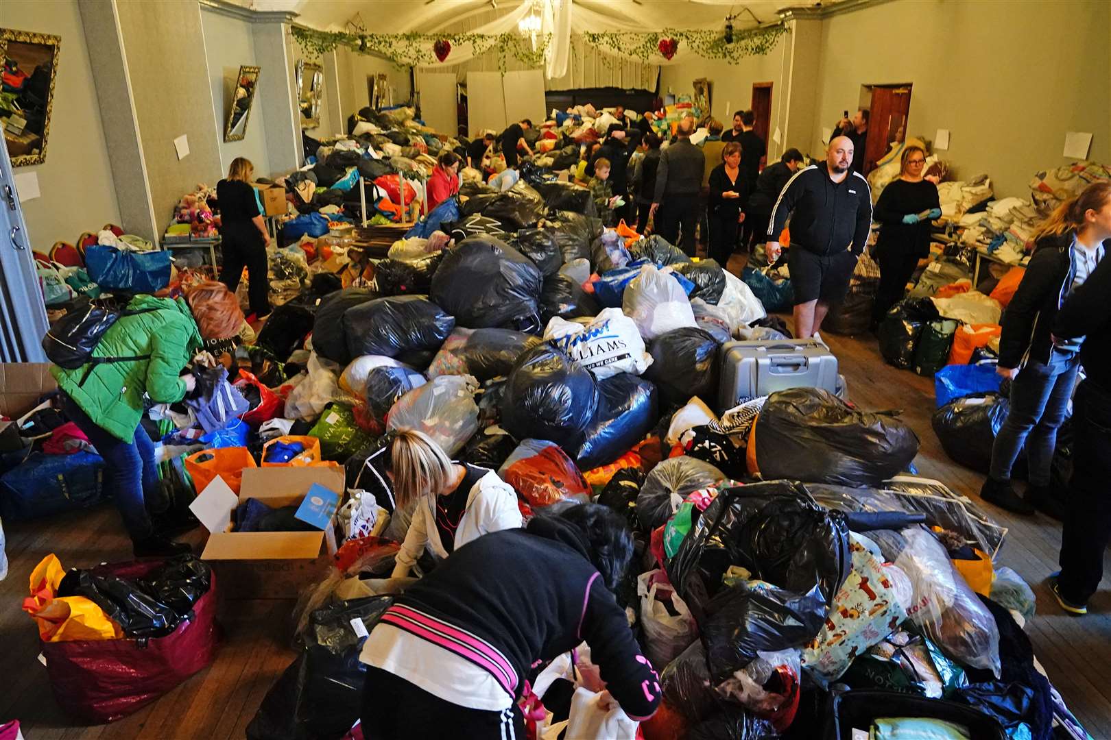 Volunteers sorting through donations (Aaron Chown/PA)