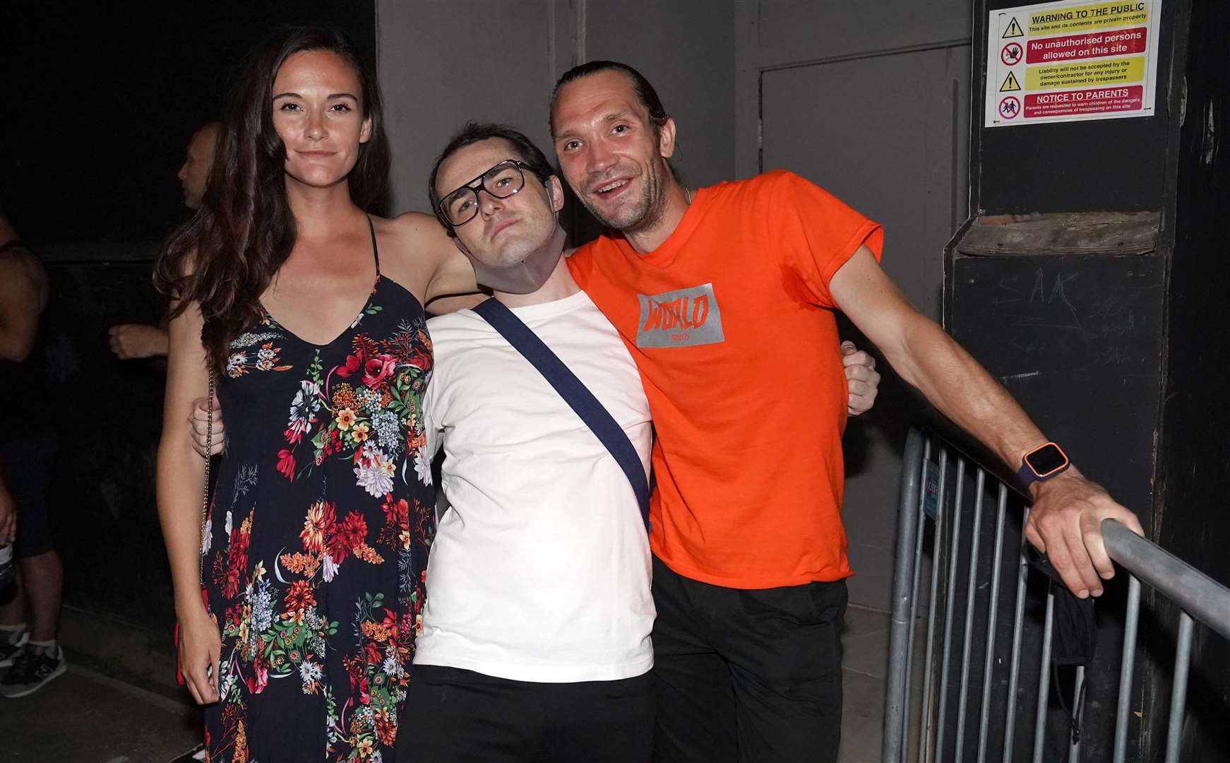 (Left to right) Chloe Waite, Gabriel Wildsmith and Alex Clarke queue up outside a nightclub in London (Jonathan Brady/PA)