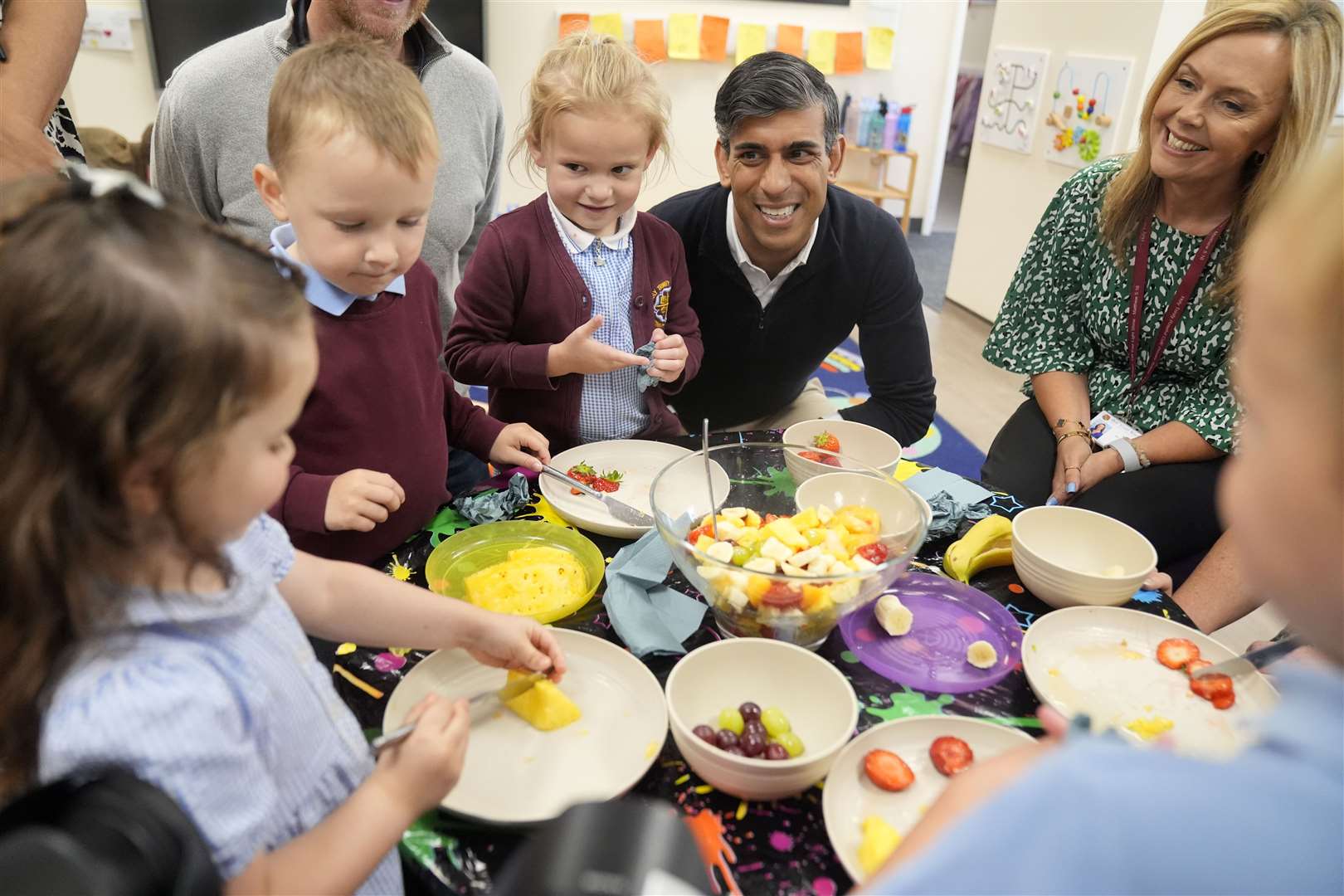 The Prime Minister watched on as the children cut up fruit in class, but was given a firm ‘No!’ by one young girl when he asked if he could take some fruit salad home (Danny Lawson/PA)