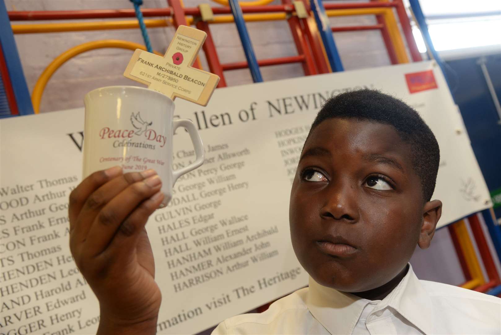 Ayomide, 10 with his Peace Day mug at Newington CE Primary School. Picture: Chris Davey (13441698)