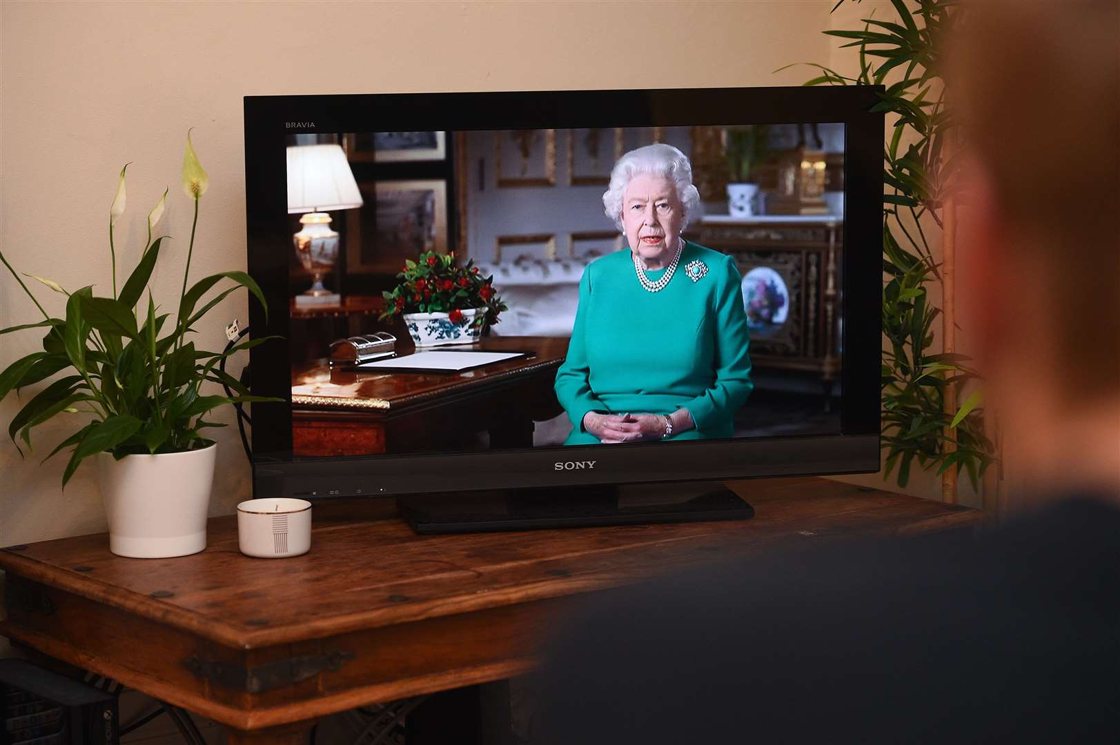 People in Wandsworth, London, watch Queen deliver her Covid address to the nation (Kirsty O’Connor/PA)