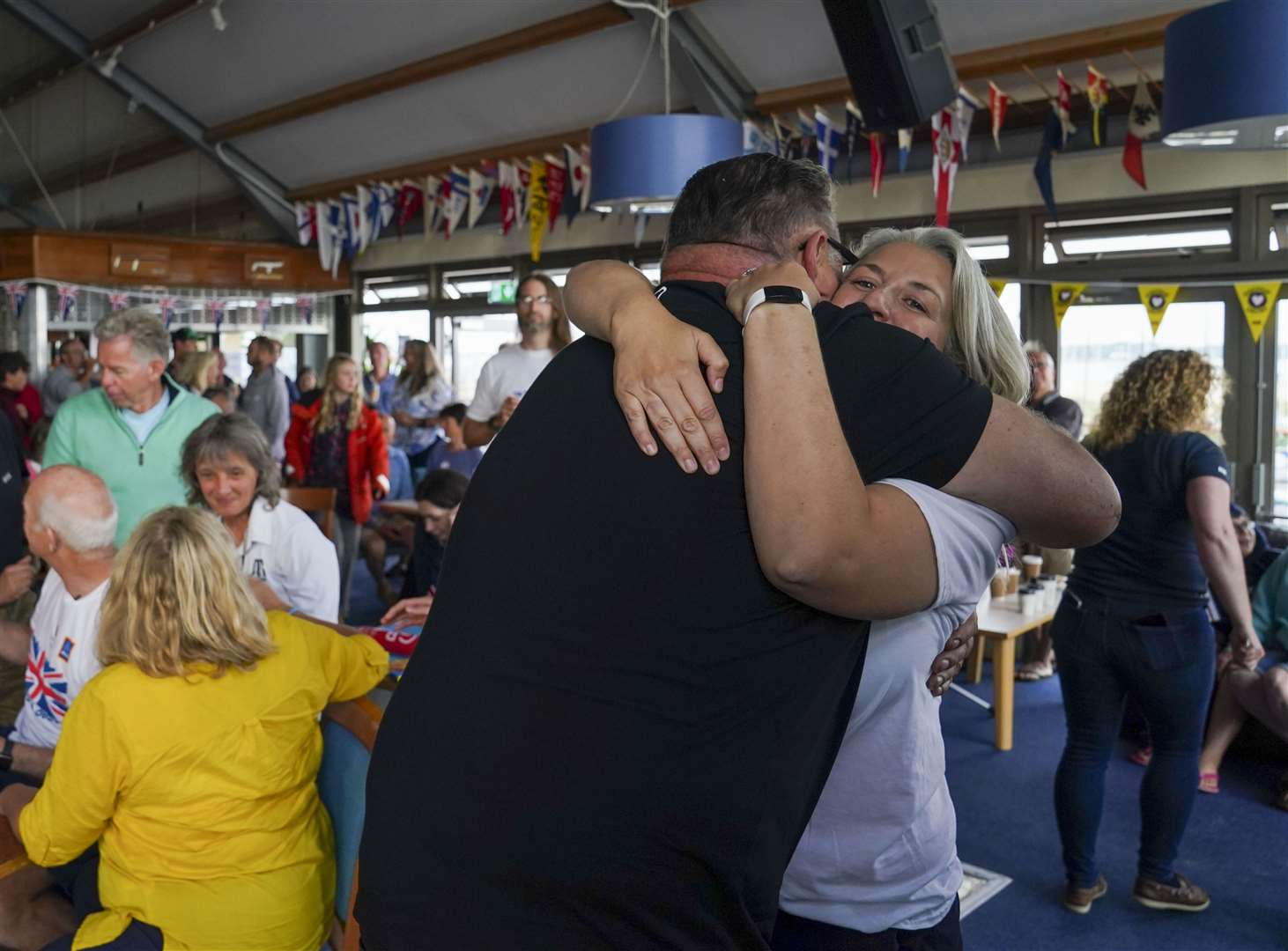 Eilidh McIntyre’s friends and family celebrate her win at Hayling Island Sailing Club, Hampshire (Steve Parsons/PA)