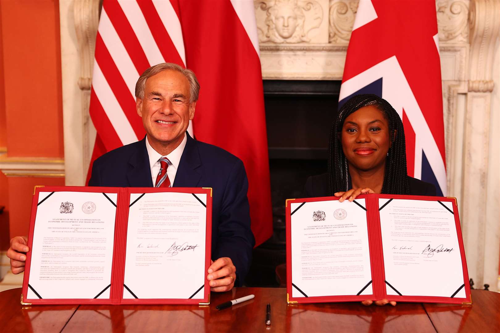 Texas Governor Greg Abbott and Business Secretary Kemi Badenoch posed for photographs with the signed agreement (Peter Nicholls/PA)