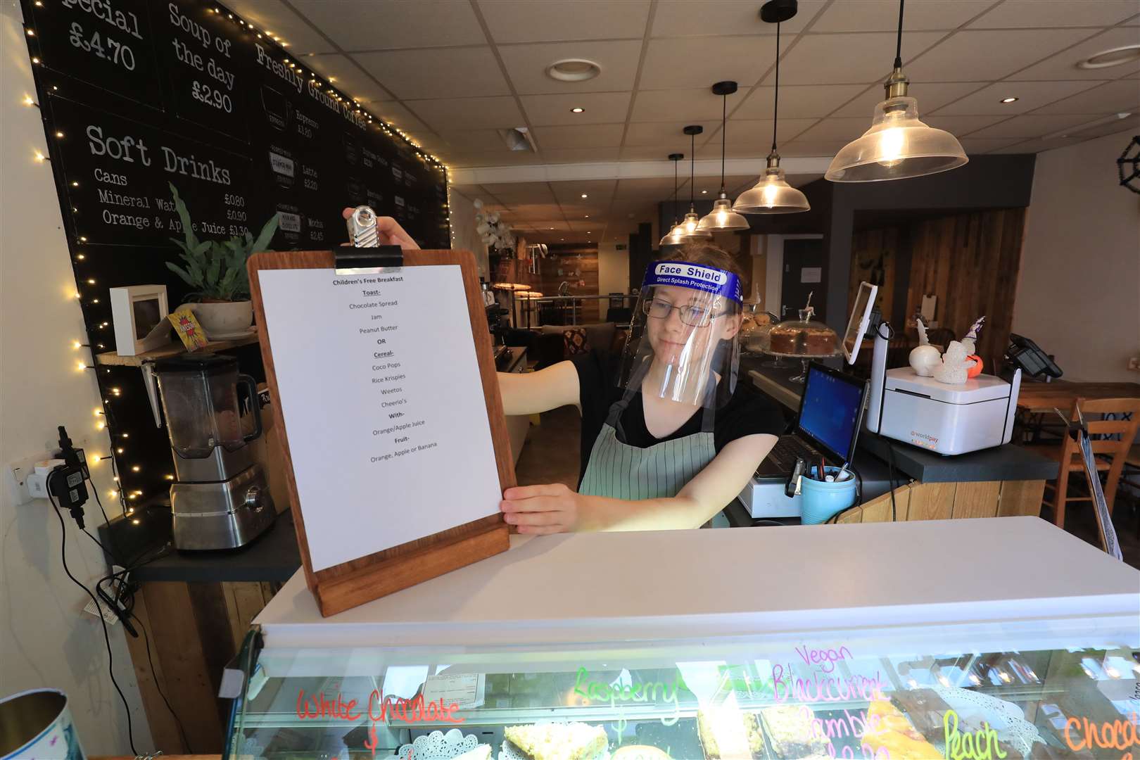 A cafe worker puts out a menu for a free breakfast for children in Kent (Gareth Fuller/PA)