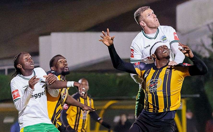 Dover defender Joe Tennent climbs above Folkestone's Marvel Ekpiteta as Whites earned a 1-0 Isthmian Premier derby victory at Cheriton Road on Tuesday. Picture: Helen Cooper