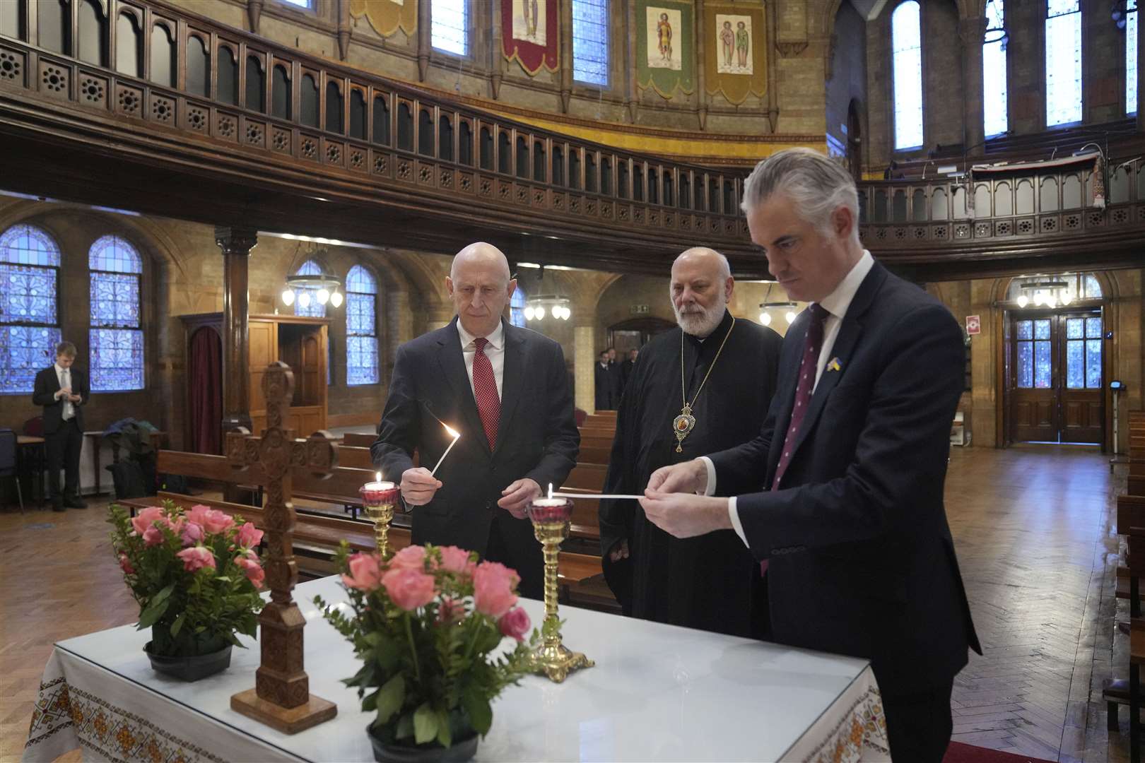 John Healey with Bishop of Ukraine Diocese Kenneth Nowakoski and shadow defence secretary James Cartlidge (Kin Cheung/PA)