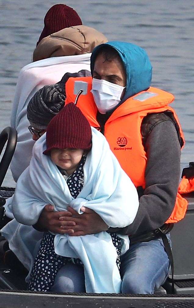 A young girl amongst a group of people thought to be migrants as they are brought in to Dover, Kent, by Border Force officers following a small boat incident in the Channel (Gareth Fuller/PA)