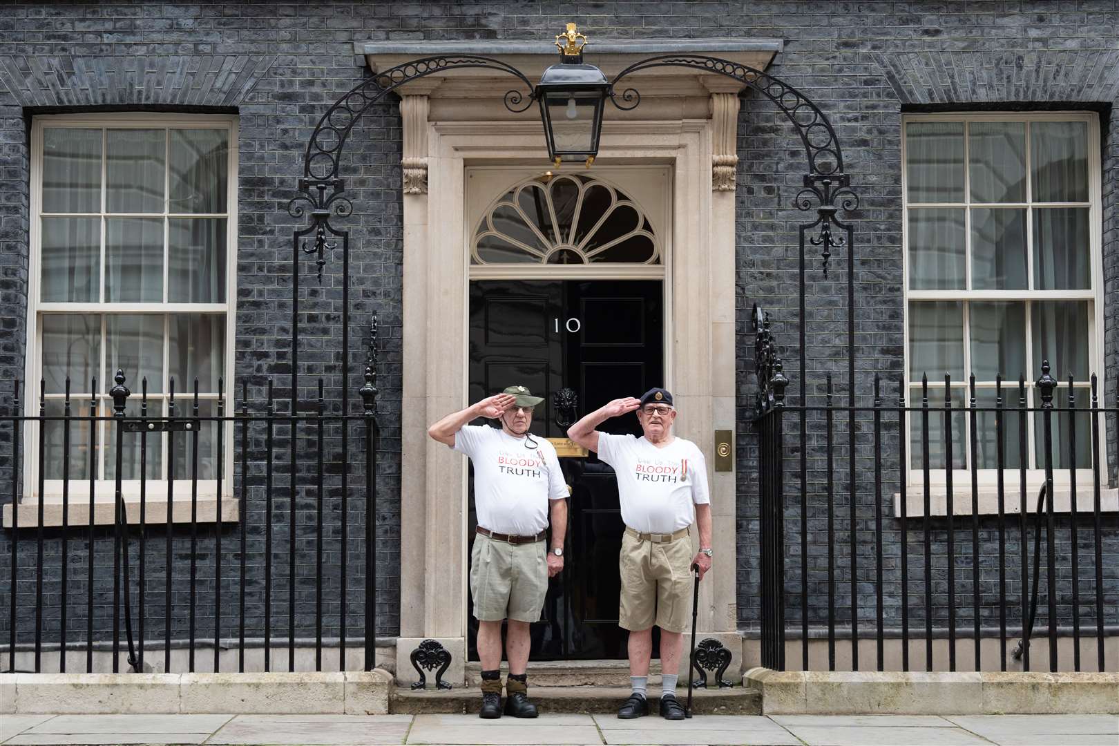 Veterans of Britain’s Cold War radiation experiments Terry Quinlan (left) and Brian Unthank (right) hand a petition in at Downing Street to formally launch proceedings against the UK Ministry of Defence (Stefan Rousseau/PA)