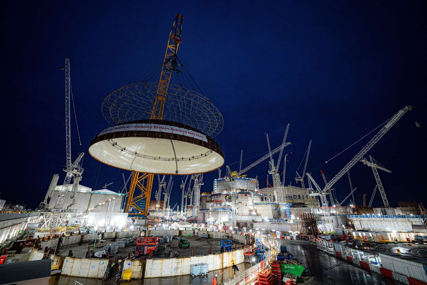 The steel dome being lifted onto Hinkley Point C’s first reactor building (Ben Birchall/PA)