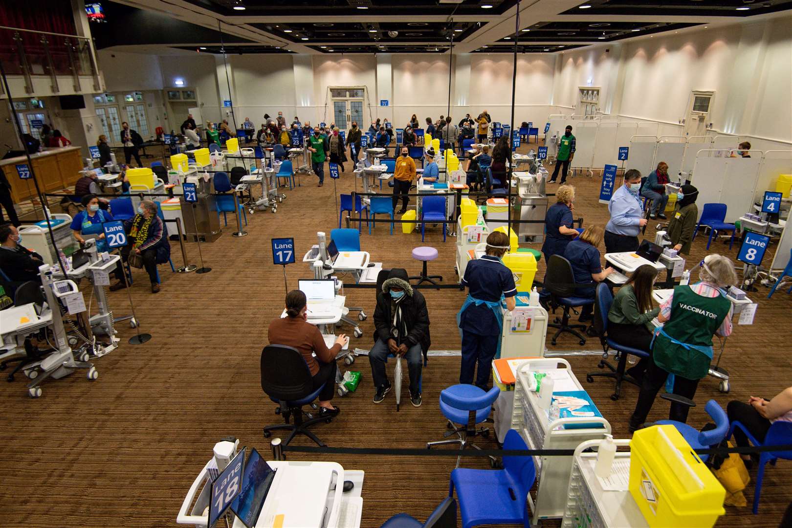 People receive their Covid-19 vaccinations at Villa Park (Jacob King/PA)