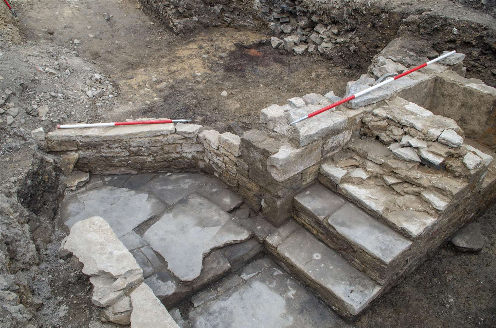 The excavated walls and staircase at the castle (Wessex Archaeology/PA)