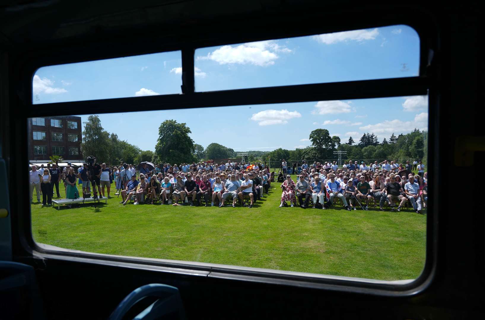 The audience for one of the campaign speeches, seen through the window of the Reform UK campaign bus in Maidstone, Kent on June 24 (Jordan Pettitt/PA)