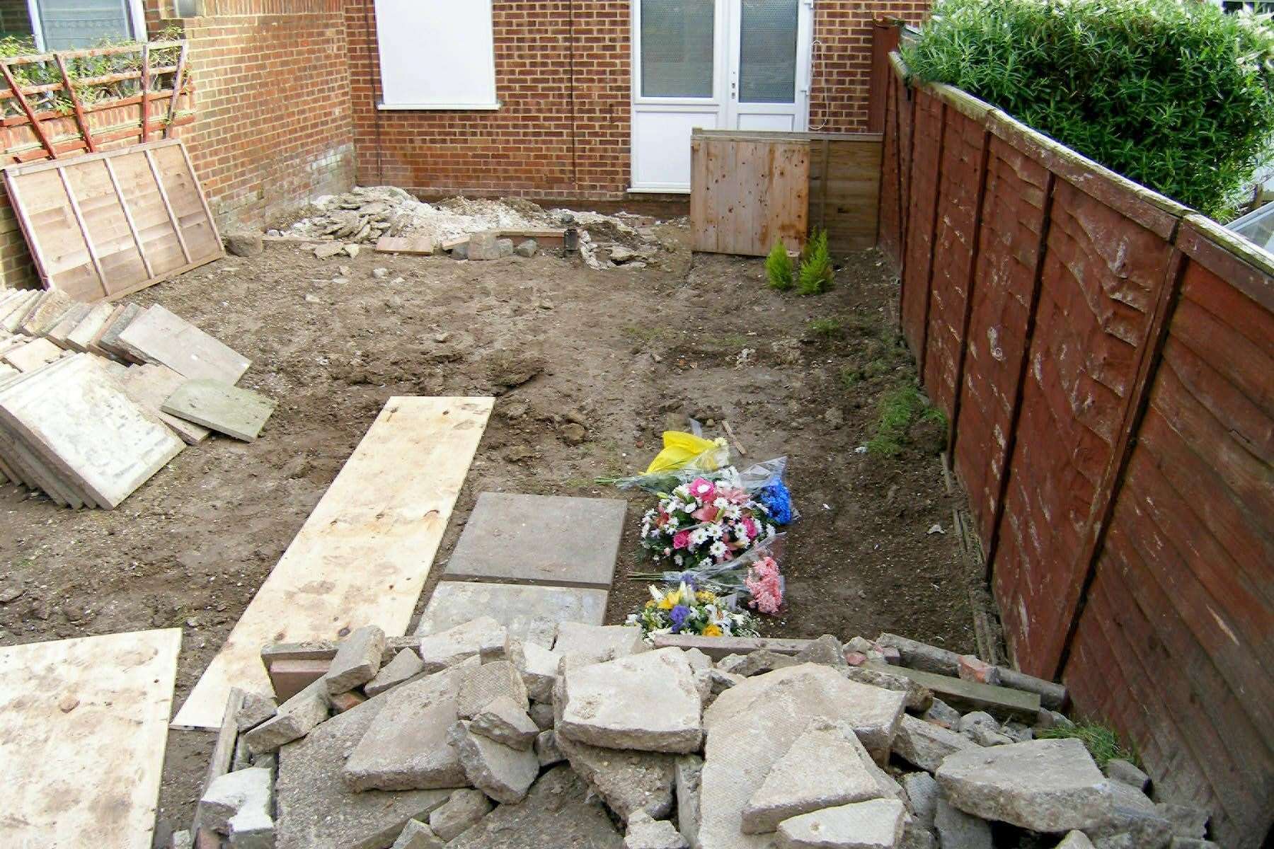 Floral tributes laid in the garden in Margate where the remains of 15-year-old Vicky Hamilton were found (Mike Pett/PA)