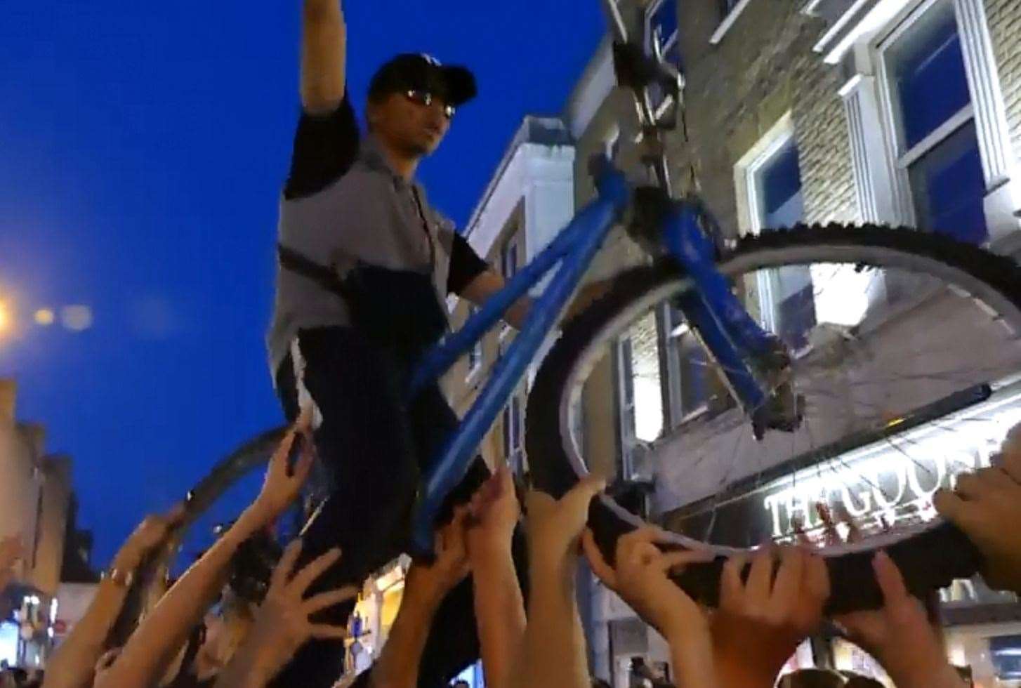 The moment a cyclist was lifted up by England fans following their last 16 victory over Colombia