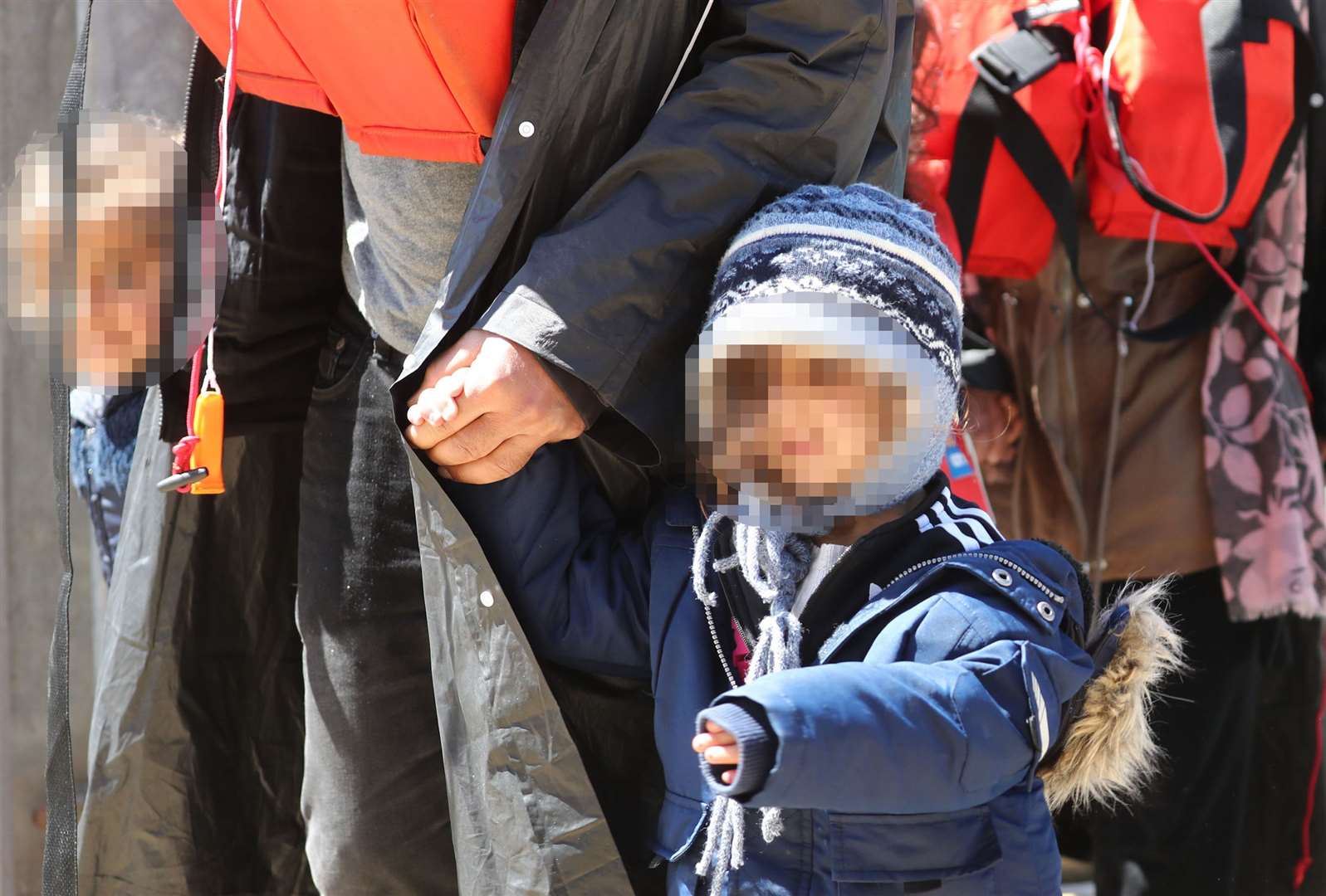 A group of people, including children, are brought in to Dover (Gareth Fuller/PA)