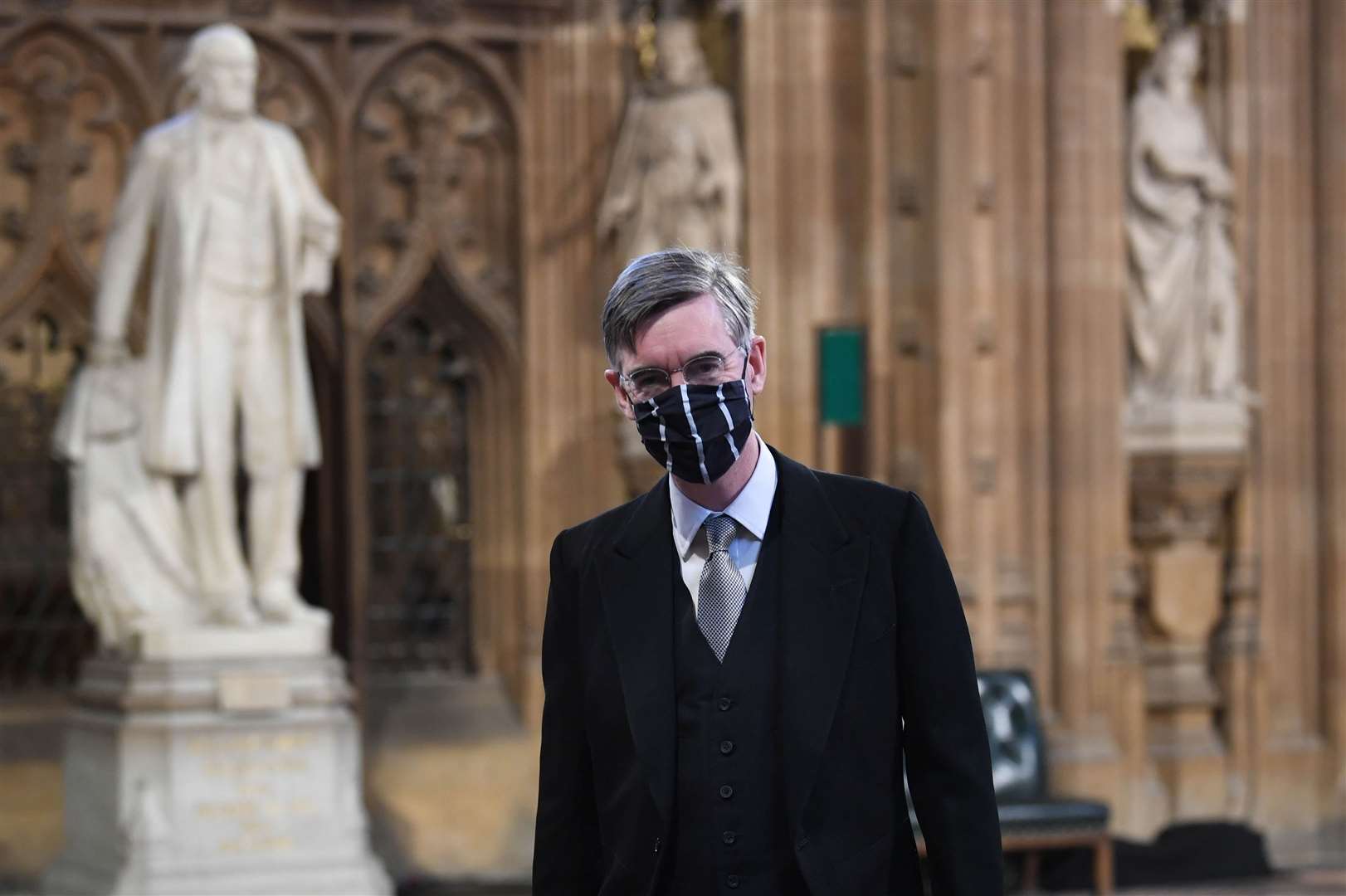 House of Commons Leader Jacob Rees-Mogg wears a mask in Central Lobby ahead of the Queen’s Speech (Stefan Rousseau/PA)