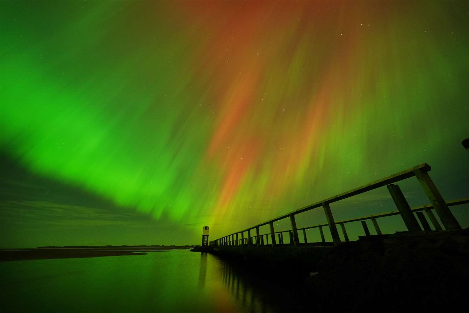 Aurora displays occur when charged particles collide with gases in the Earth’s atmosphere around the magnetic poles (Owen Humphreys/PA)