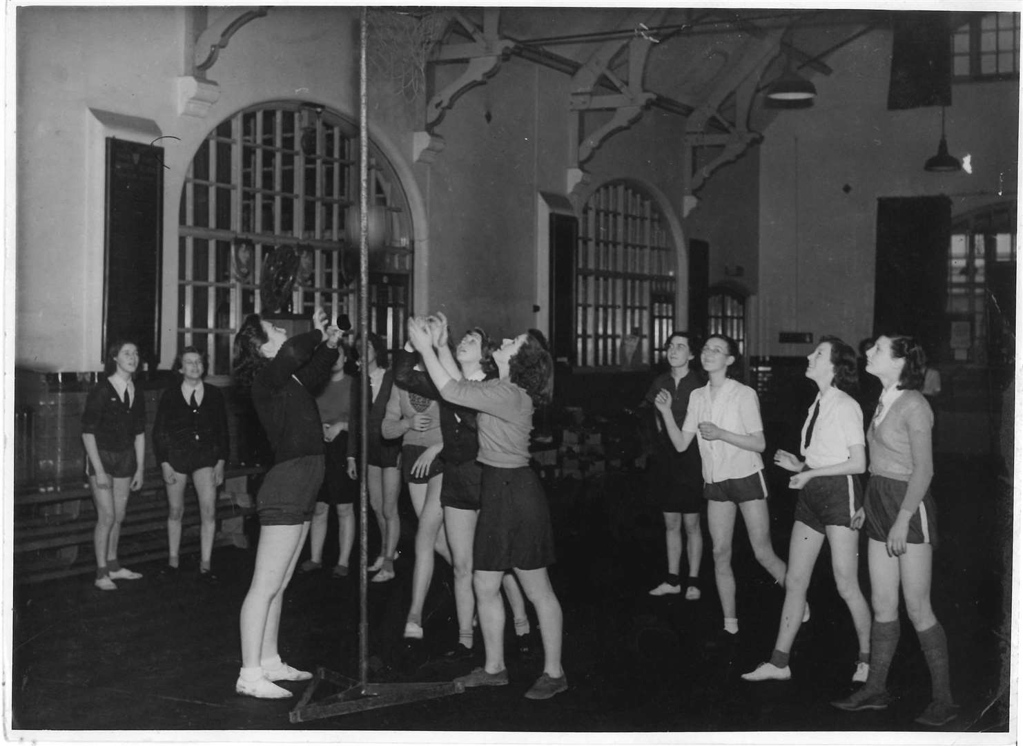 Pam Woolmer shooting in a game of netball at East Borough school, Maidstone. She is to the right of the post, in lighter top at the front. Photo supplied by Pam Woolmer